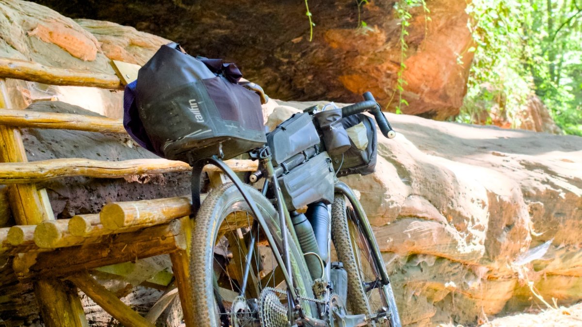 Tailfin CargoPack monté sur un vélo de bikepacking lors d’un test terrain en forêt