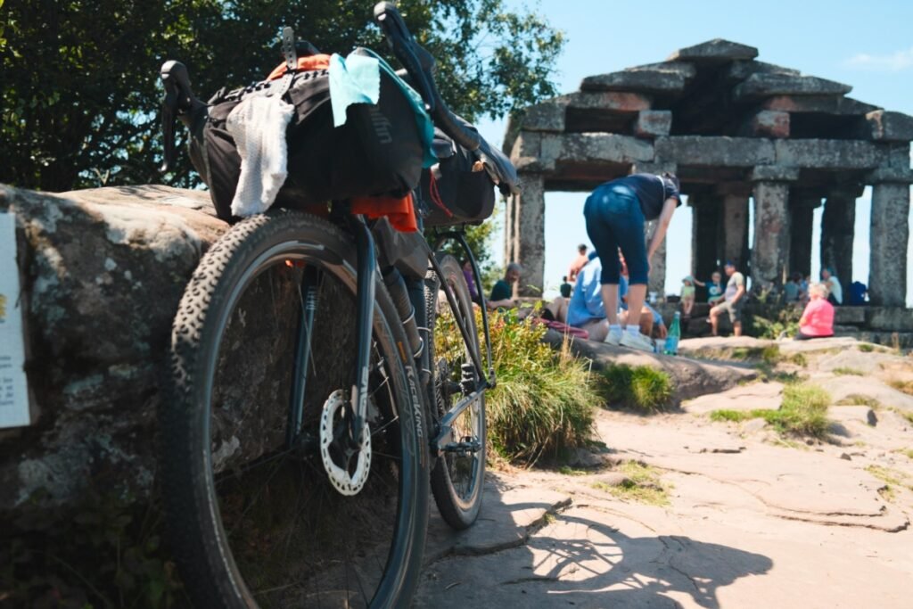 Bikepacking : c’est quoi exactement ? 6 Vélo de bikepacking chargé lors d’une pause, au cœur d’un site naturel fréquenté